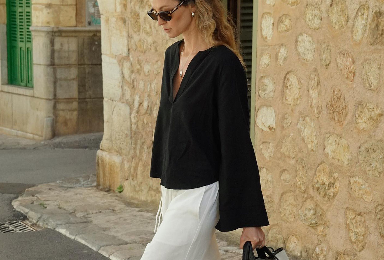 Woman wearing a linen shirt and pants outfit.