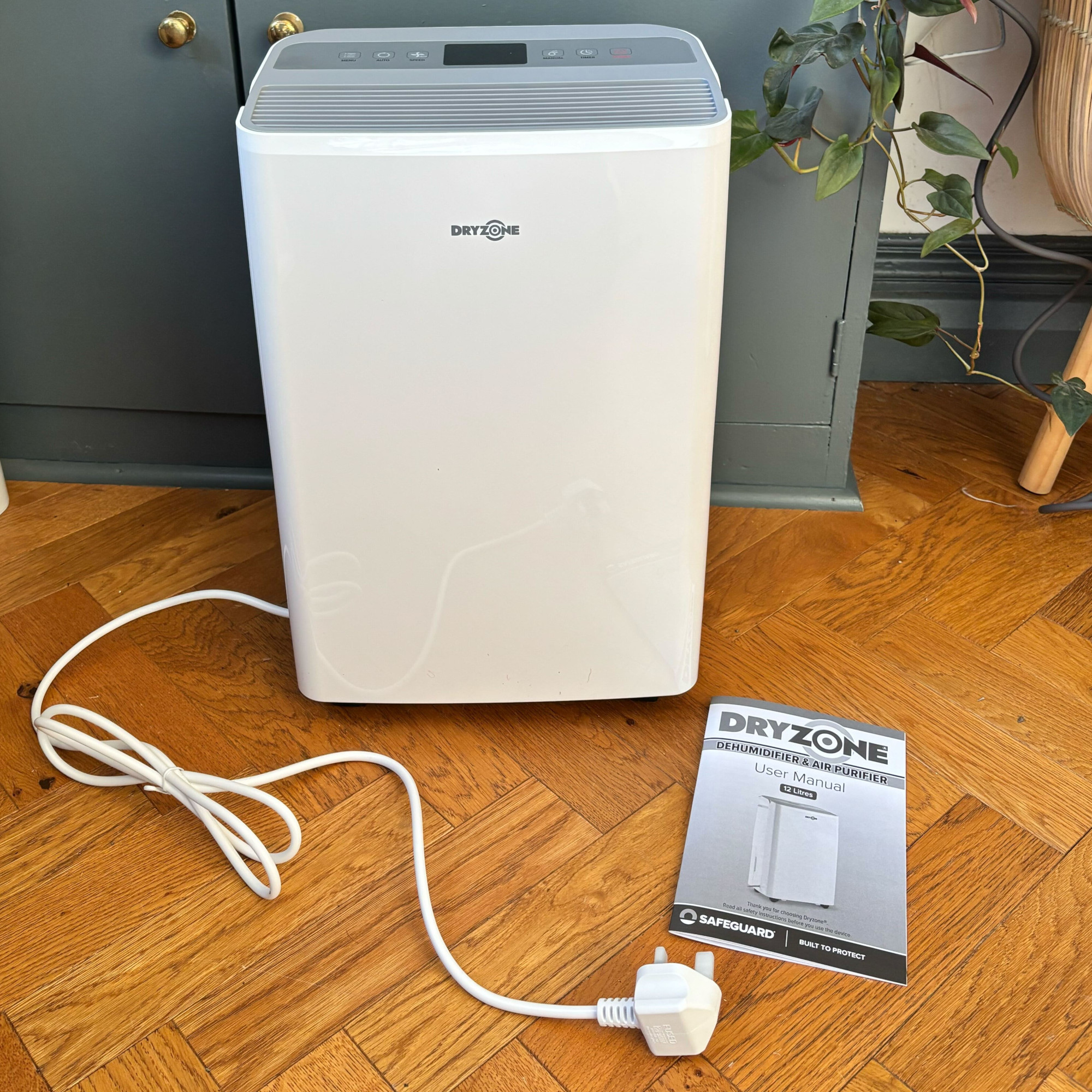 dryzone dehumidifier unboxed in a hallway with parquet floor