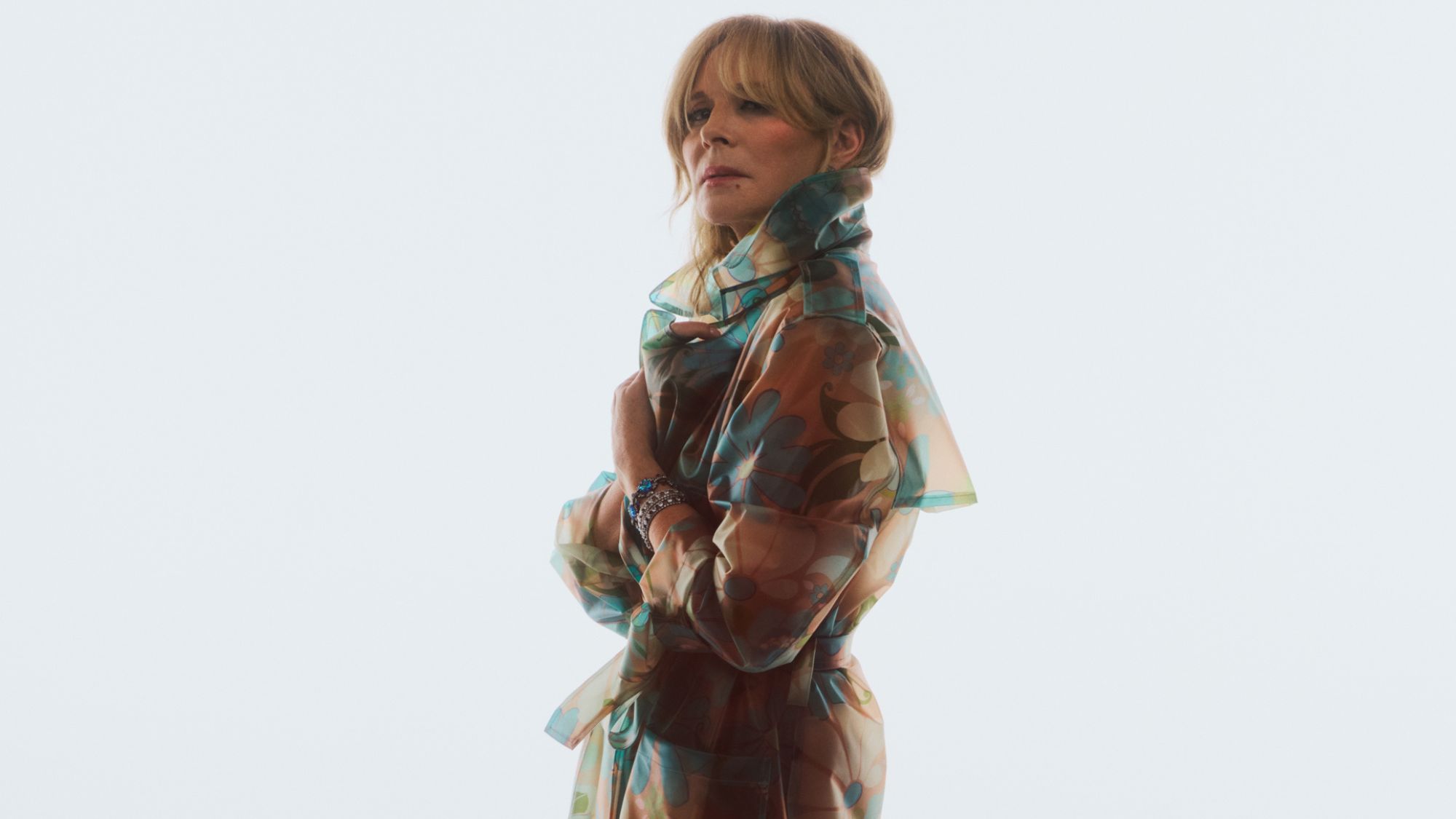 kim cattrall poses in a sheer trench coat for the new designers at debenhams x ashish campaign