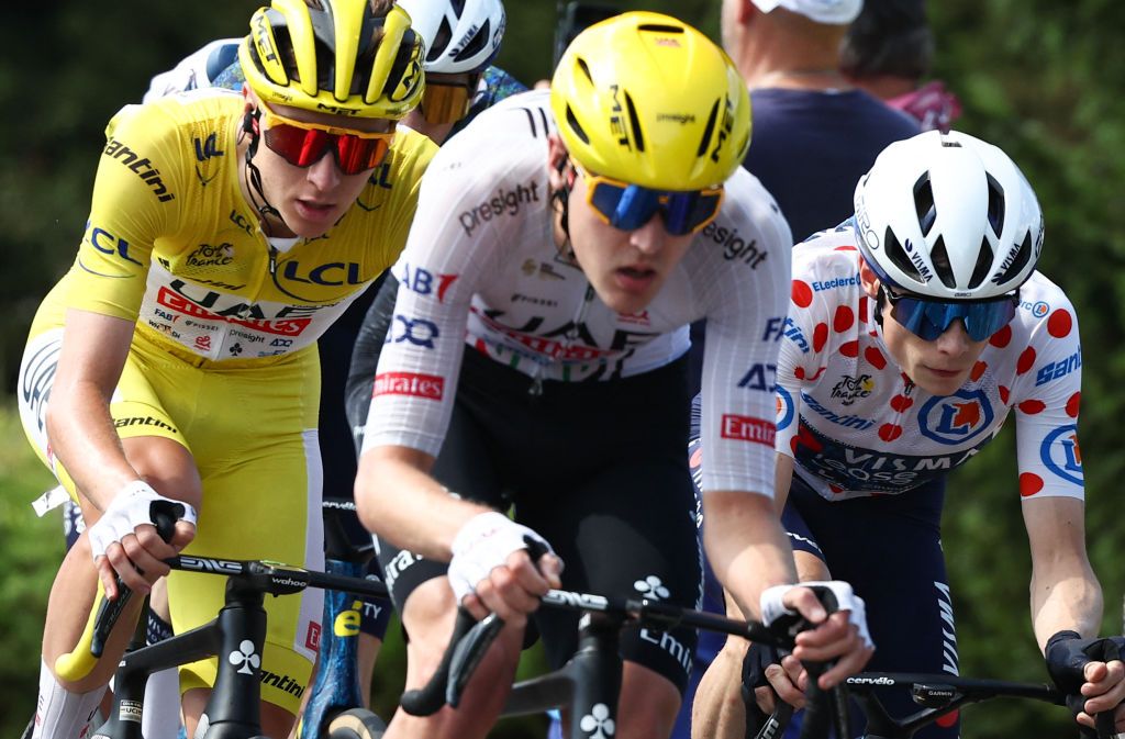 UAE Team Emirates team&#039;s Slovenian rider Tadej Pogacar wearing the overall leader&#039;s yellow jersey (L) and Team Visma - Lease a Bike team&#039;s Danish rider Jonas Vingegaard wearing the climber&#039;s polka dot (dotted) jersey (second placed in the category) cycle during the 16th stage of the 111th edition of the Tour de France cycling race, 188,6 km between Gruissan and Nimes, southern France, on July 16, 2024. (Photo by Anne-Christine POUJOULAT / AFP)