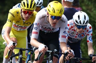UAE Team Emirates team's Slovenian rider Tadej Pogacar wearing the overall leader's yellow jersey (L) and Team Visma - Lease a Bike team's Danish rider Jonas Vingegaard wearing the climber's polka dot (dotted) jersey (second placed in the category) cycle during the 16th stage of the 111th edition of the Tour de France cycling race, 188,6 km between Gruissan and Nimes, southern France, on July 16, 2024. (Photo by Anne-Christine POUJOULAT / AFP)