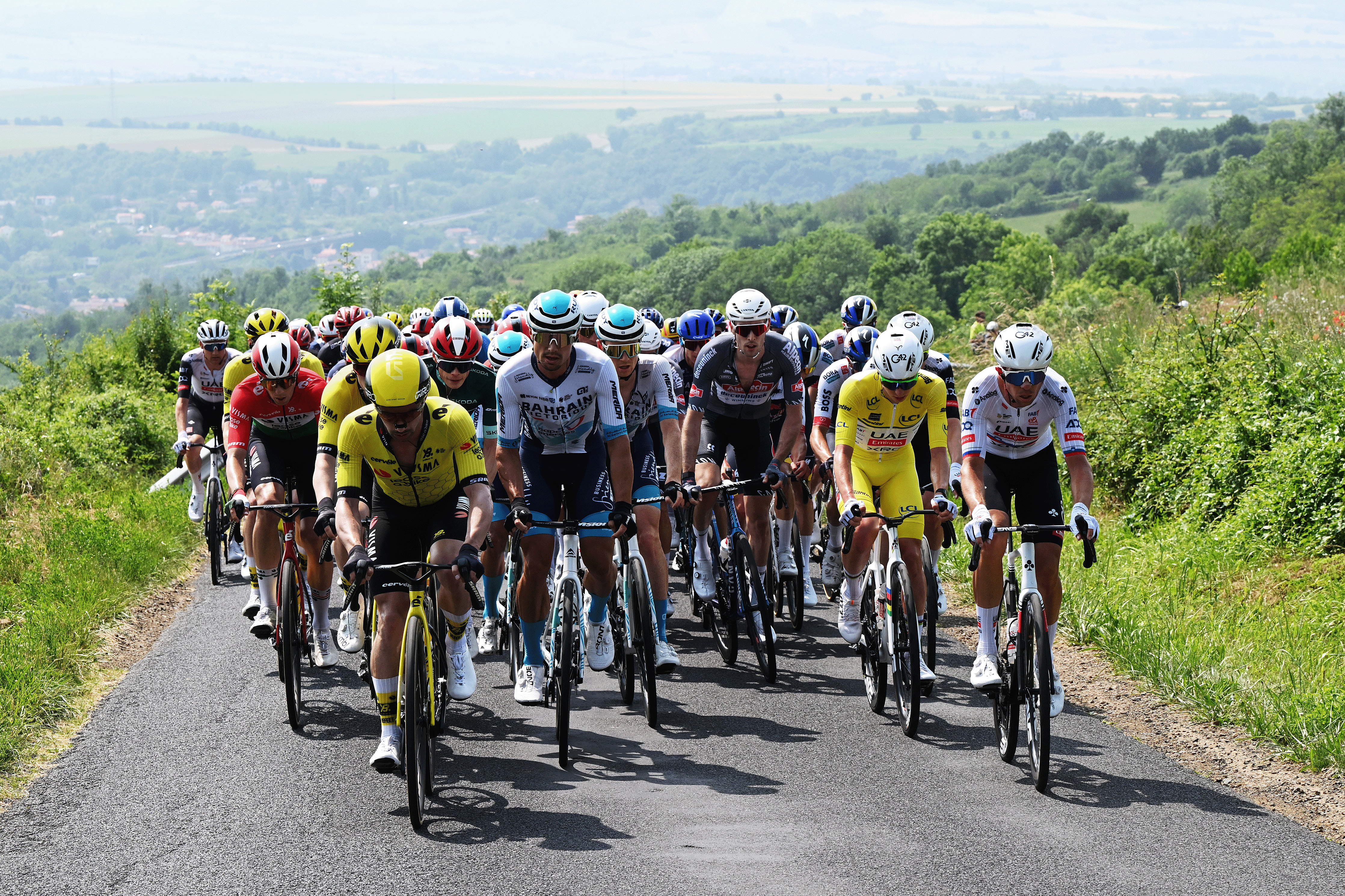ISSOIRE, FRANCE - JUNE 09: (L-R) Attila Valter of Hungary, Victor Campenaerts of Belgium and Team Visma | Lease a Bike, Robert Stannard of Australia and Team Bahrain - Victorious, Michael Gogl of Austria and Team Alpecin - Deceuninck, Tadej Pogacar of Slovenia - Yellow leader jersey, Domen Novak of Slovenia and UAE Team Emirates - XRG compete during the 77th Criterium du Dauphine 2025, Stage 2 a 204.6km stage from Premilhat to Issoire / #UCIWT / on June 09, 2025 in Issoire, France. (Photo by Dario Belingheri/Getty Images)