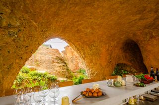 Food on long table within cave like structure in japan