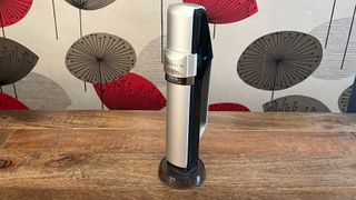 The sparkling charger, which is part of the Coravin Sparkling wine preservation system, on a wooden table