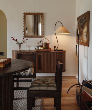 Neutral dining room with a ribbed wooden sideboard