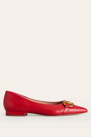 red flat shoes with gold hardware