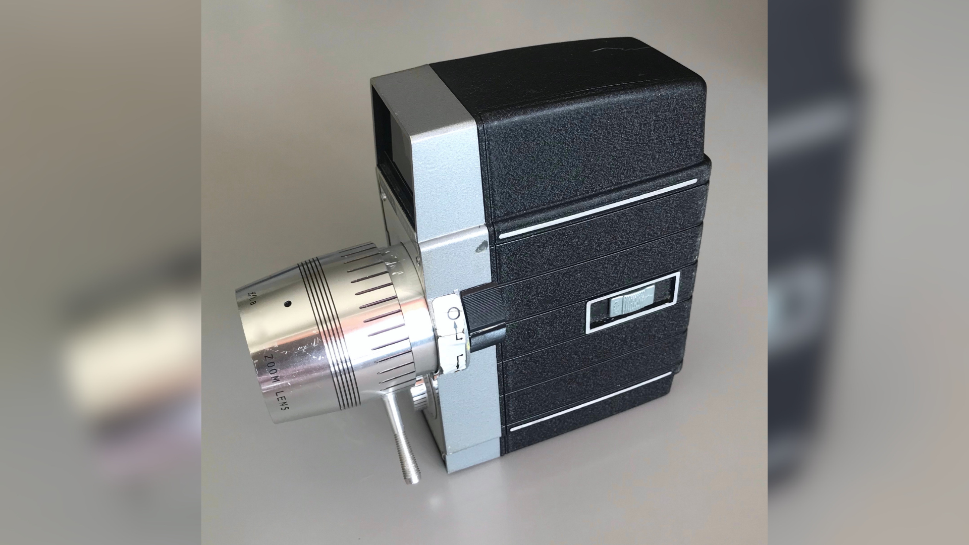 A vintage 8mm camera on a blurred background