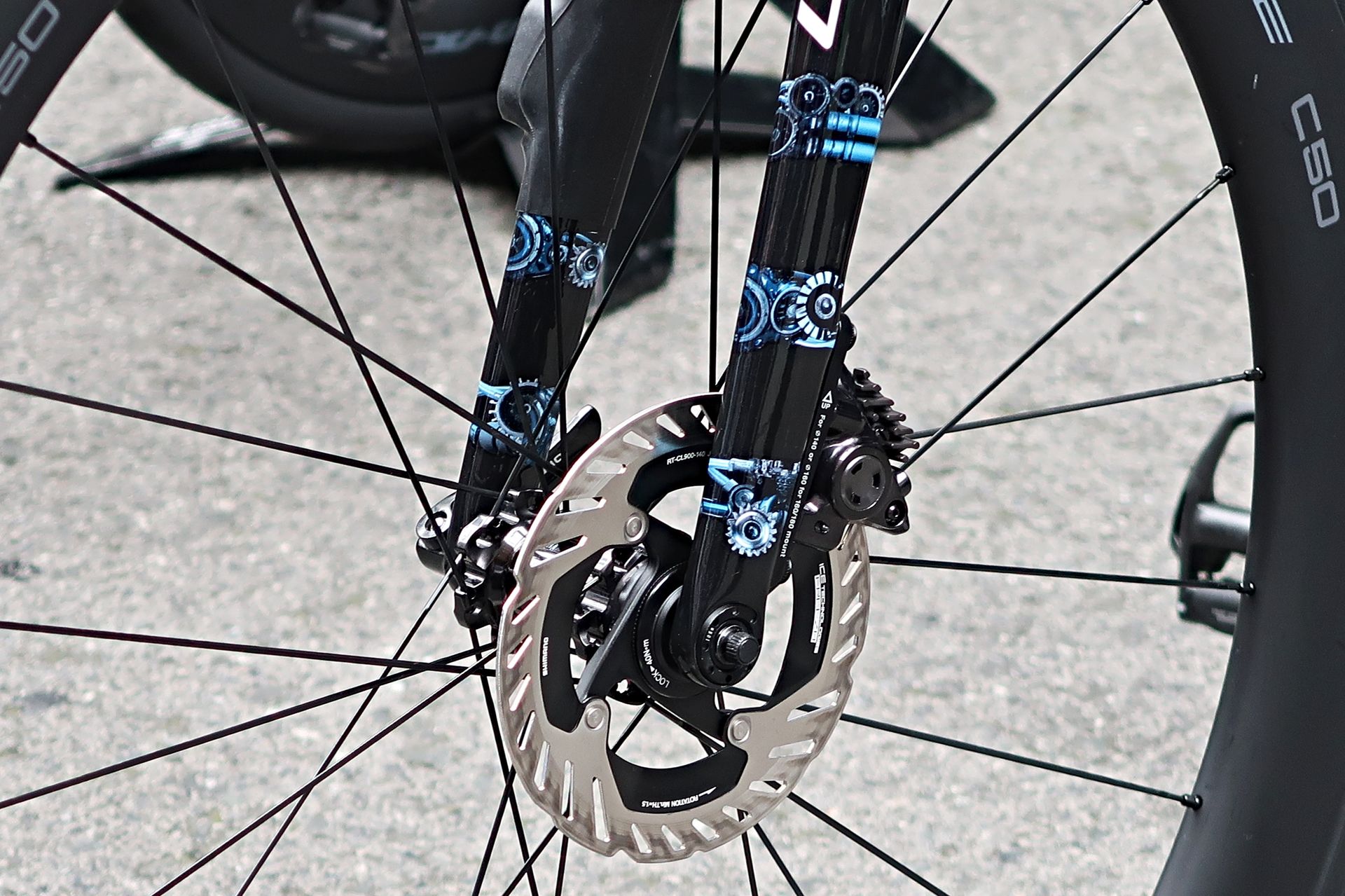 A close-up of a blue AI paint job on a bike fork
