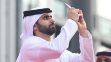 Sheikh Mansour Bin Mohammed Bin Rashid Al Maktoum takes a photo with his phone