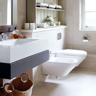 bathroom with tiles and washbasin