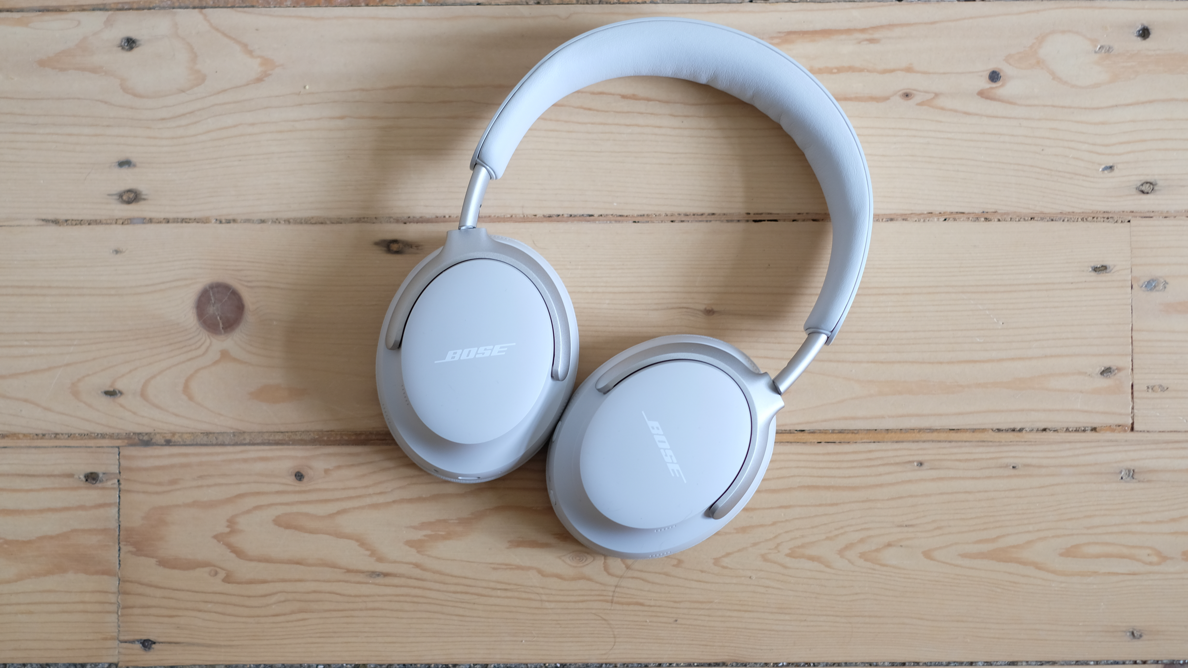 Bose QuietComfort Ultras photograph on wooden floor