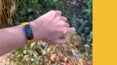 Grace Walsh testing the Fitbit Inspire 3 fitness tracker on wrist on sunny day outdoors