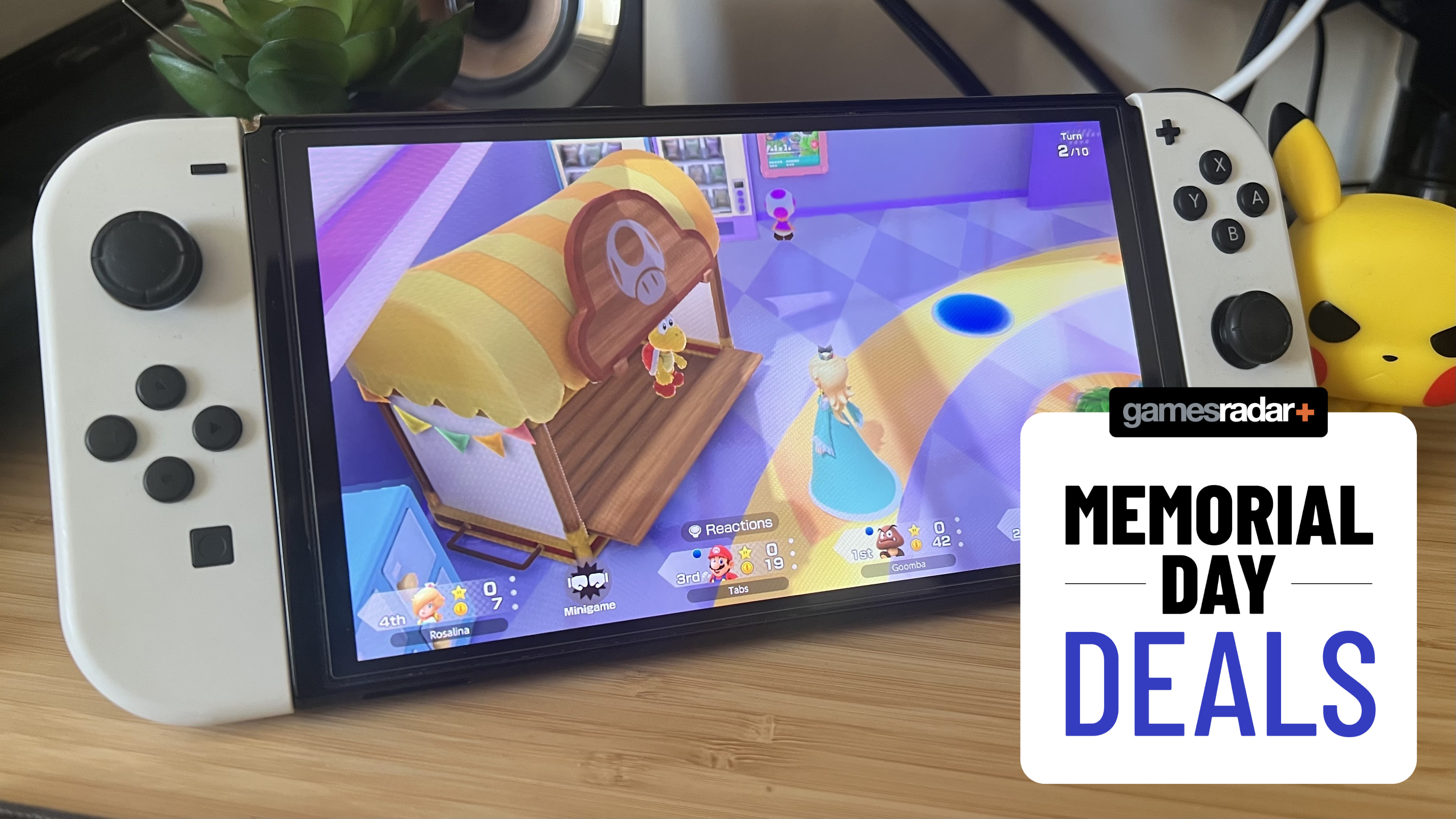 Nintendo Switch OLED playing Mario Party Jamboree with Memorial Day deals badge