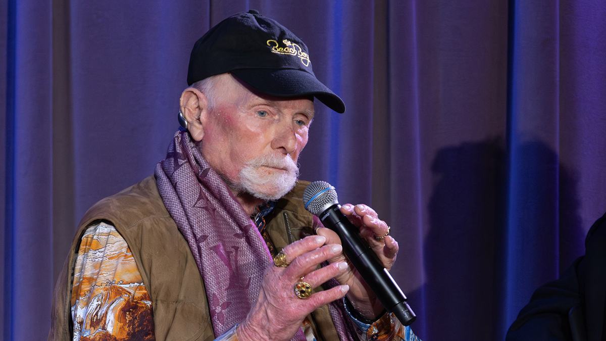 LOS ANGELES, CALIFORNIA - FEBRUARY 12:  Mike Love and Howie Edelson speak onstage at Celebrating The Beach Boys' We Gotta Groove: The Brother Studio Years at GRAMMY Museum L.A. Live on February 12, 2026 in Los Angeles, California.  (Photo by Alison Buck/Getty Images for The Recording Academy)