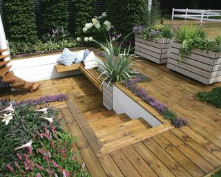 sunken deck area with steps, bench and planters