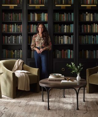 Magnolia Home by Joanna Gaines x Loloi portrait shot in a home library with wall to wall bookshelves and a seating area