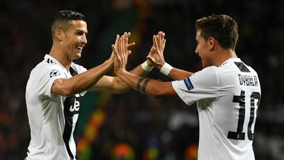 Juventus strikers Paulo Dybala and Cristiano Ronaldo celebrate the winner against Man Utd