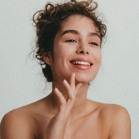 Woman stroking chin and smiling