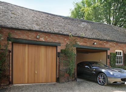 Timber garage door on gravel driveway of barn