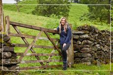 Helen Skelton posing by a fence in the countryside wearing jacket from GO Outdoors