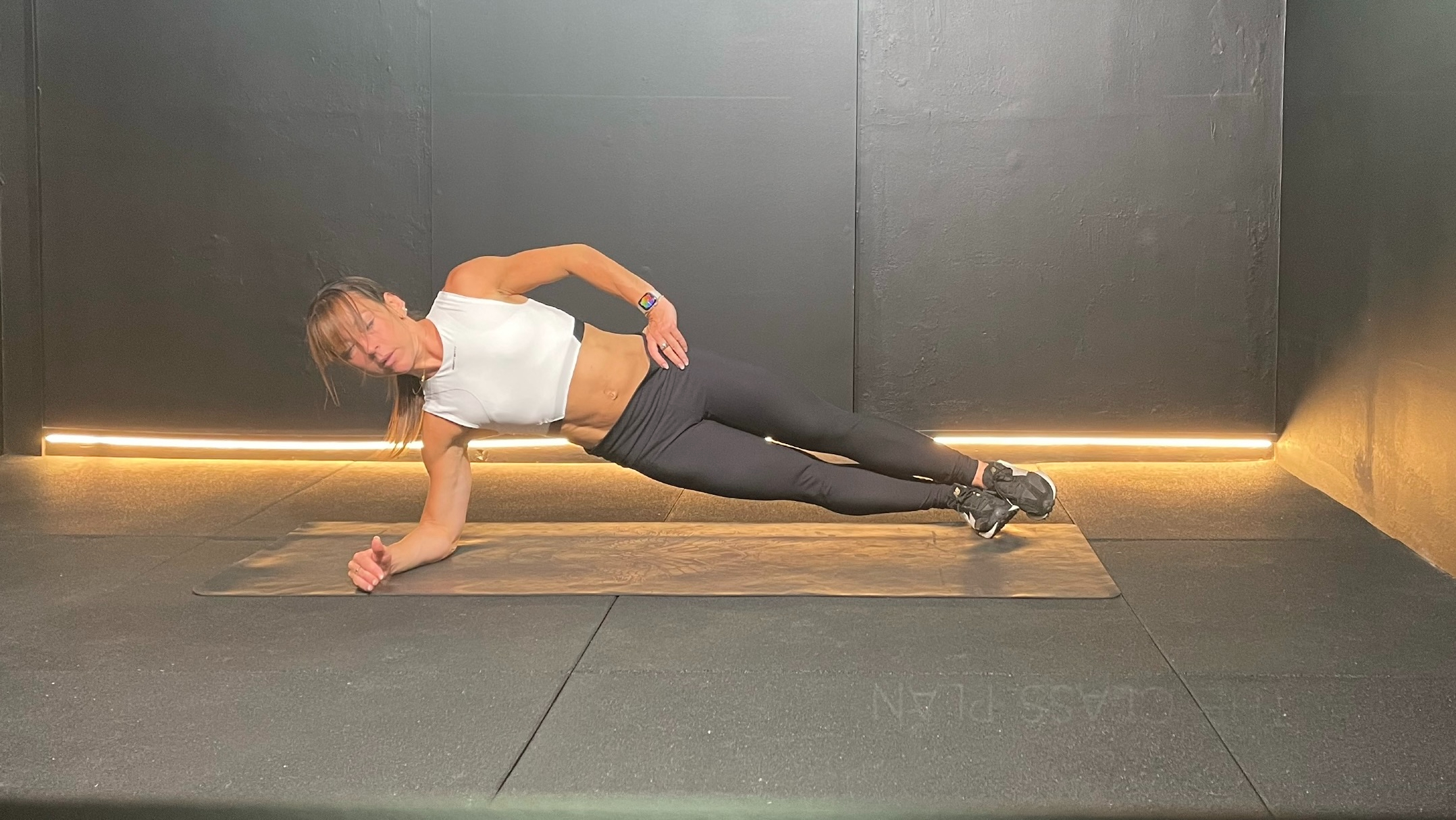 Lucy Miller holding a side plank