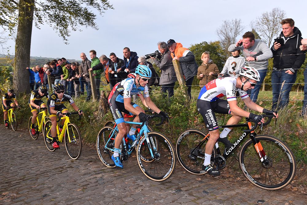 Michael Boros and Kevin Pauwels climb the Koppenberg