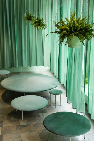 Furniture at spa with green curtains