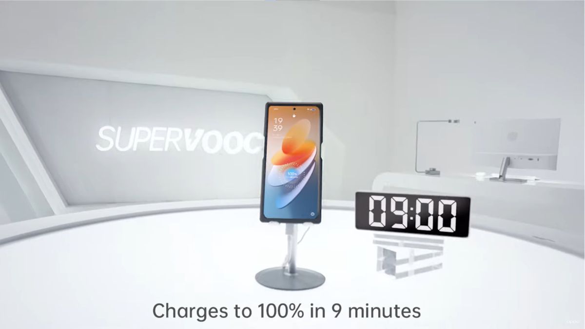 A screenshot from a video demonstration of Oppo&#039;s 240W charging technology. After 9 minutes, the phone is 100% filled, according to a timer next to a demo phone and the charging indicator on the phone itself.