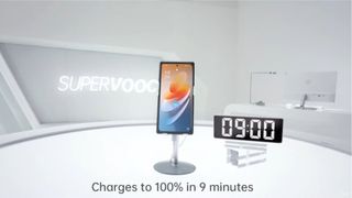A screenshot from a video demonstration of Oppo's 240W charging technology. After 9 minutes, the phone is 100% filled, according to a timer next to a demo phone and the charging indicator on the phone itself.