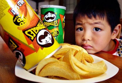 A Japanese boy looks at potato chips