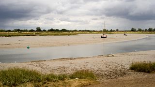 Moored boats and yachts at low tide on Maldon Estuary in Essex