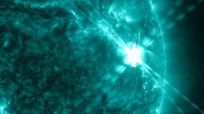 A bright flash on the sun as the solar flare explodes