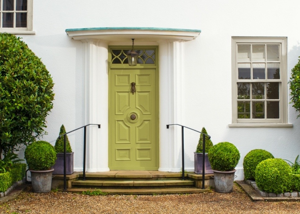 chartreuse green front door on white stucco home