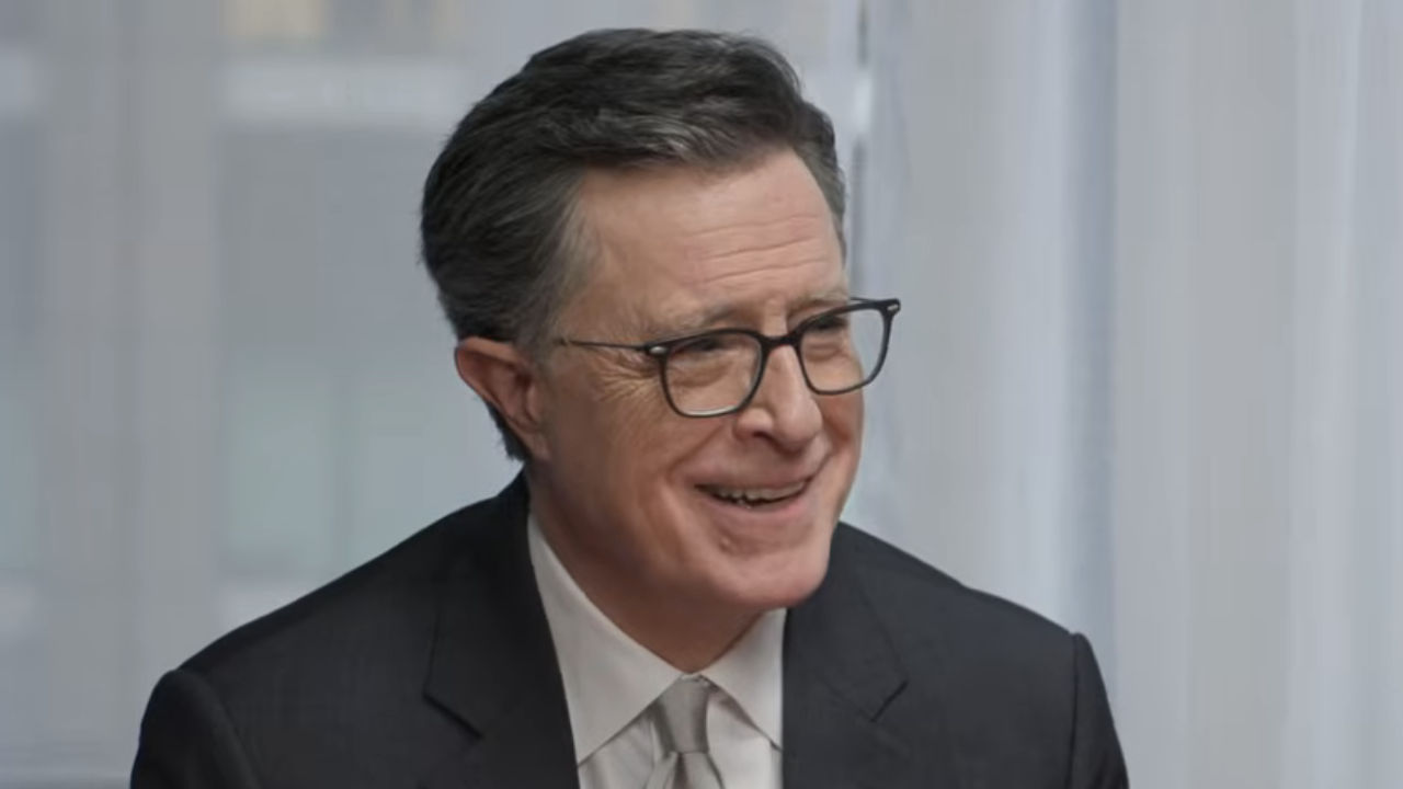 Stephen Colbert smiling while telling story during Strike Force Five reunion in May 2026