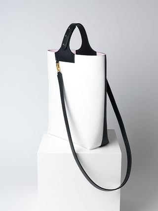 White bag with black handles and strap