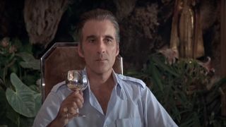Christopher Lee raises a glass in The Man with the Golden Gun.