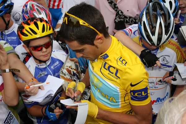 Alberto Contador signs for the fans before the race.