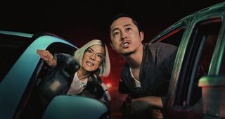 Ali Wong's Amy and Steven Yeun's Danny look furious as they lean out of their cars in Netflix's Beef season 1