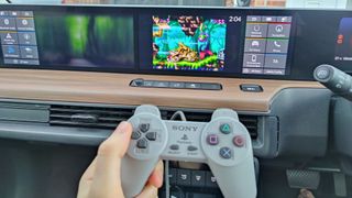 PlayStation Classic controller in front of 10-inch screen playing Rayman