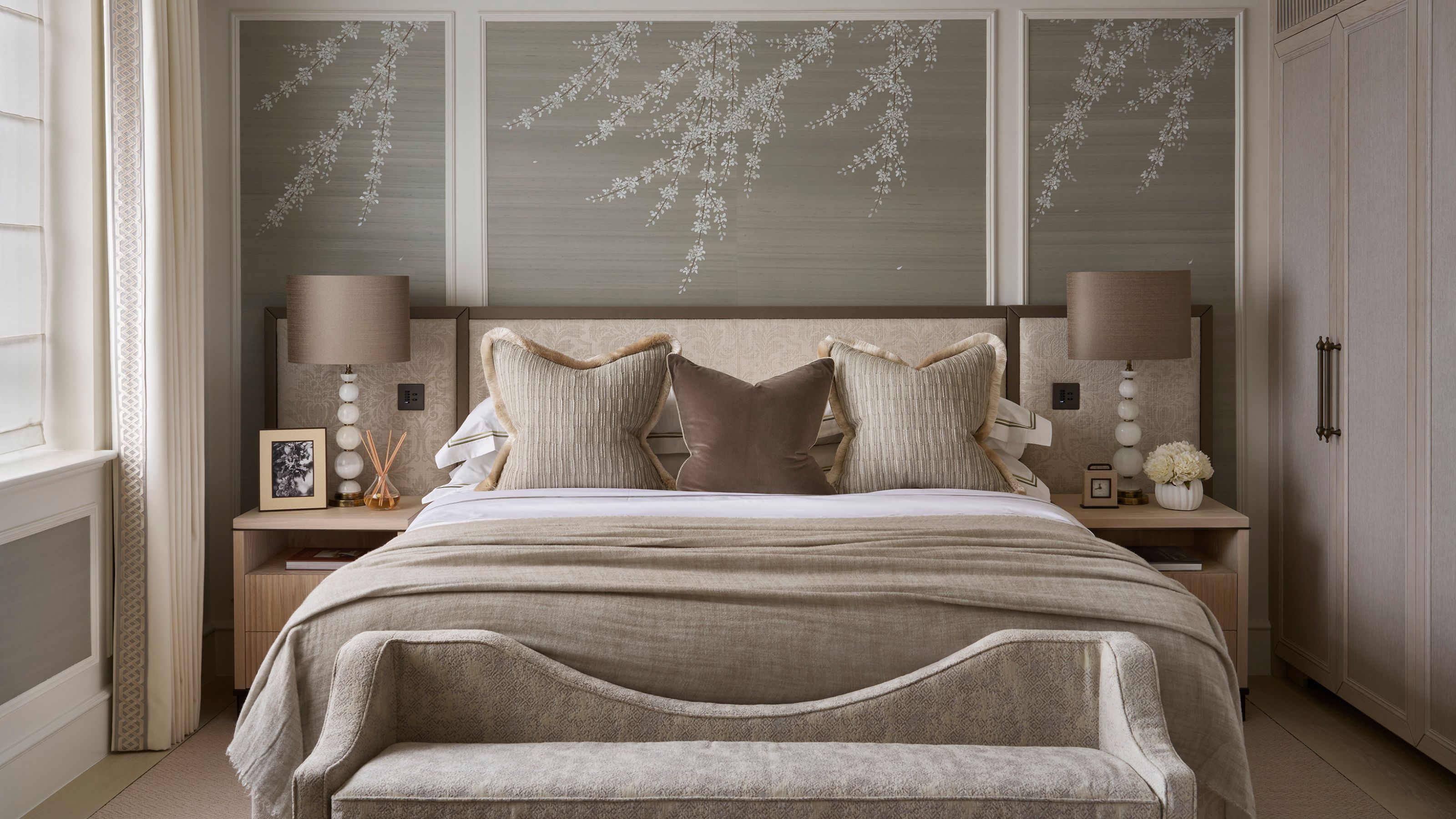 a quiet luxury london primary suite with paneled and upholstered walls and a neutral pallette