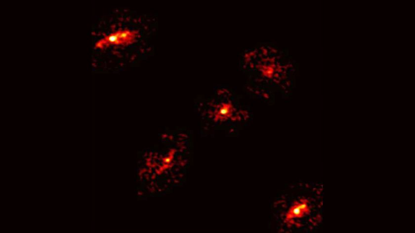 a pixelated image of five glowing blobs that form an &#039;X&#039; shape