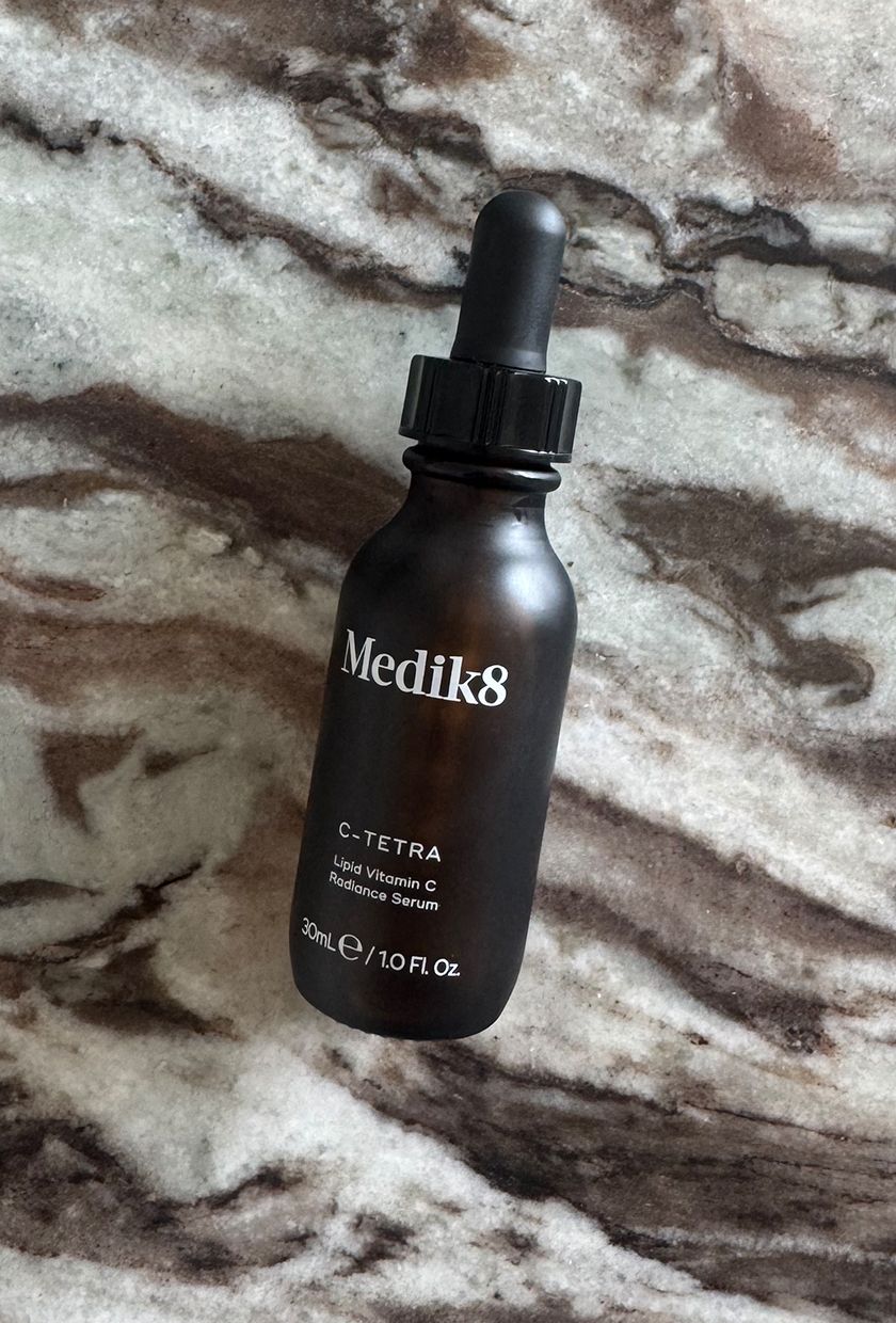 Photo of Medik8 C-Tetra Serum bottle up close on marble table
