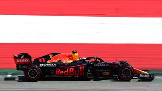 Sergio Perez of Red Bull Racing Honda drives his RB16B single-seater past Austria flag colours during qualifying of Austrian Grand Prix,