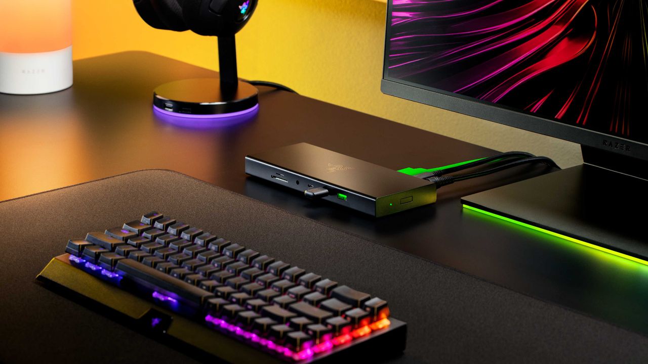 The Razer USB4 Dock on a black desk with other Razer accessories.