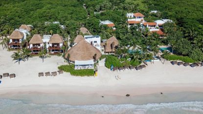 Relax at one of the thatched beach cabanas on the private beach 