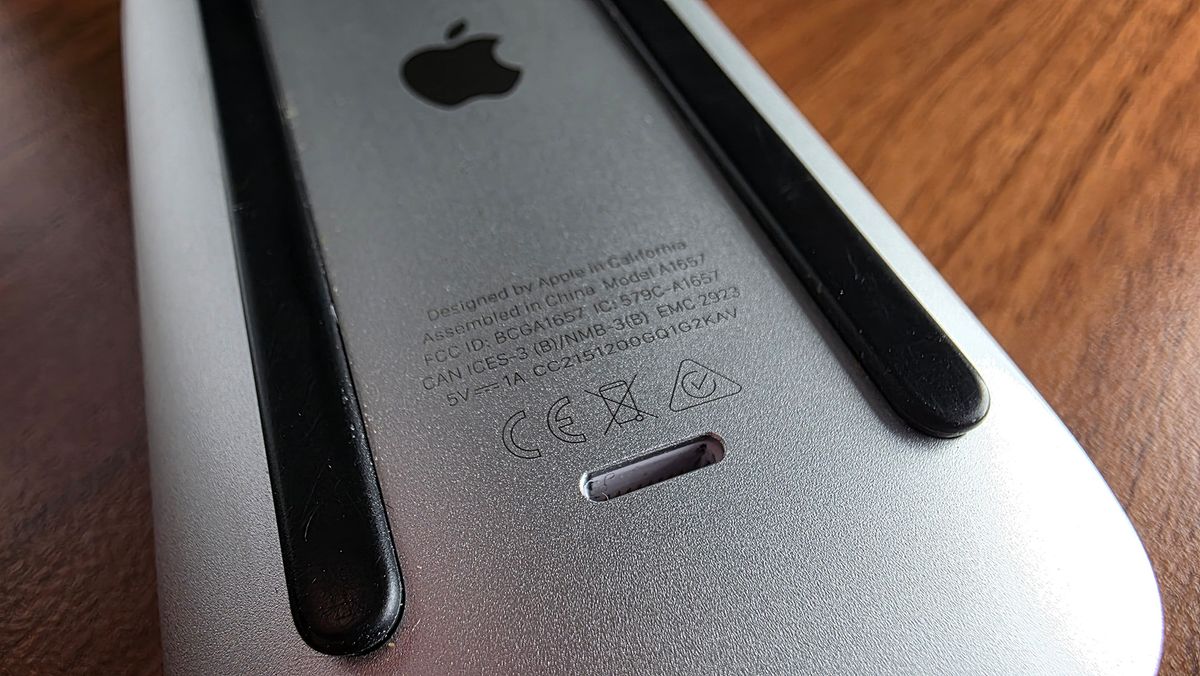 Macro photo of the bottom of an Apple Magic Mouse showing the Lightning port.