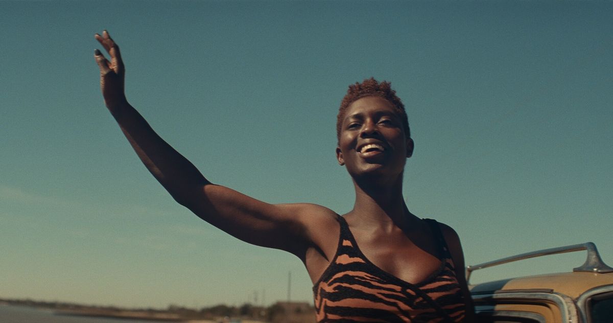 Jodie Turner-Smith waves in front of a blue sky