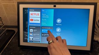 Amazon Echo Show on a counter displaying the widgets menu.