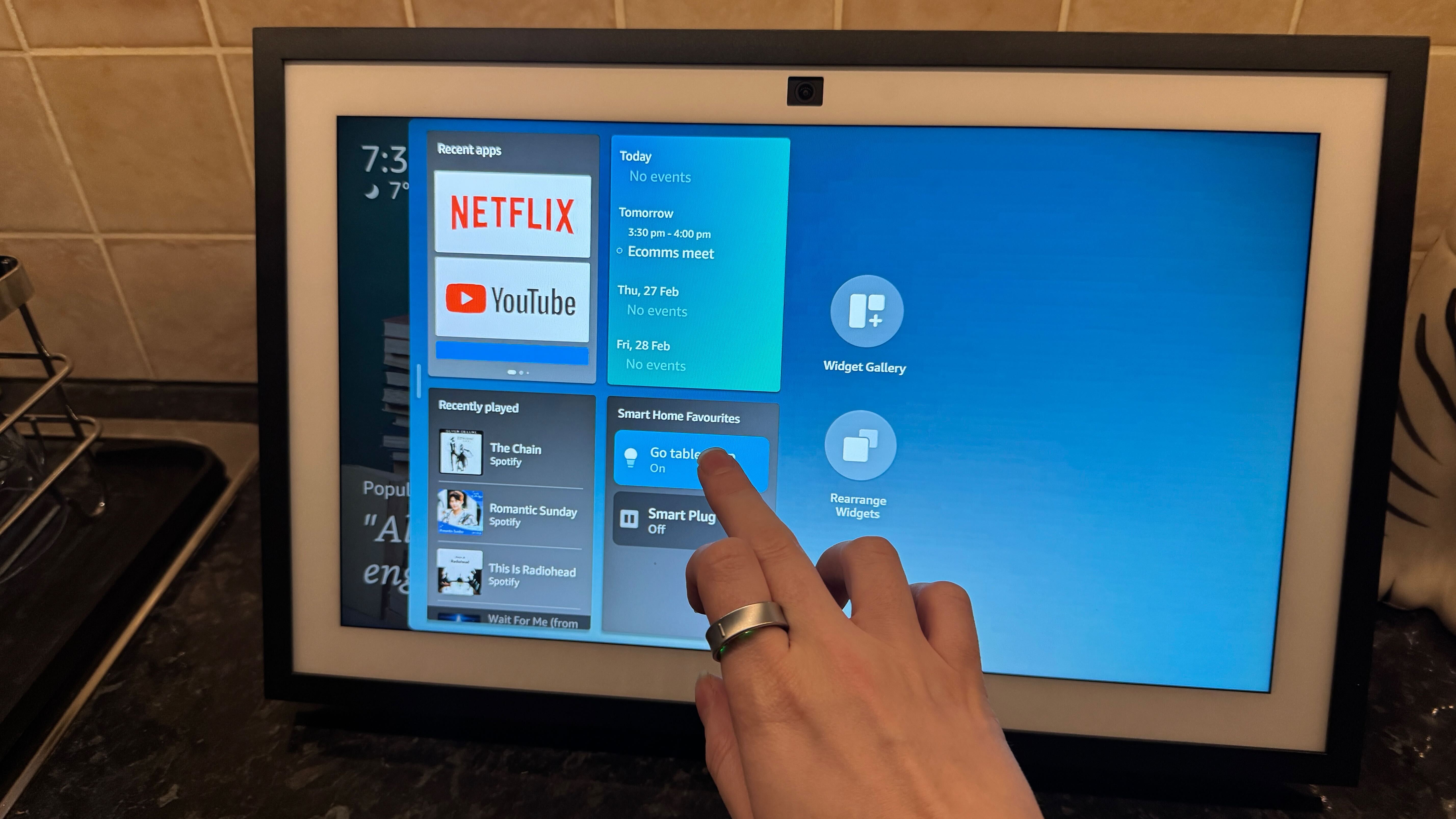 Amazon Echo Show on a counter displaying the widgets menu.