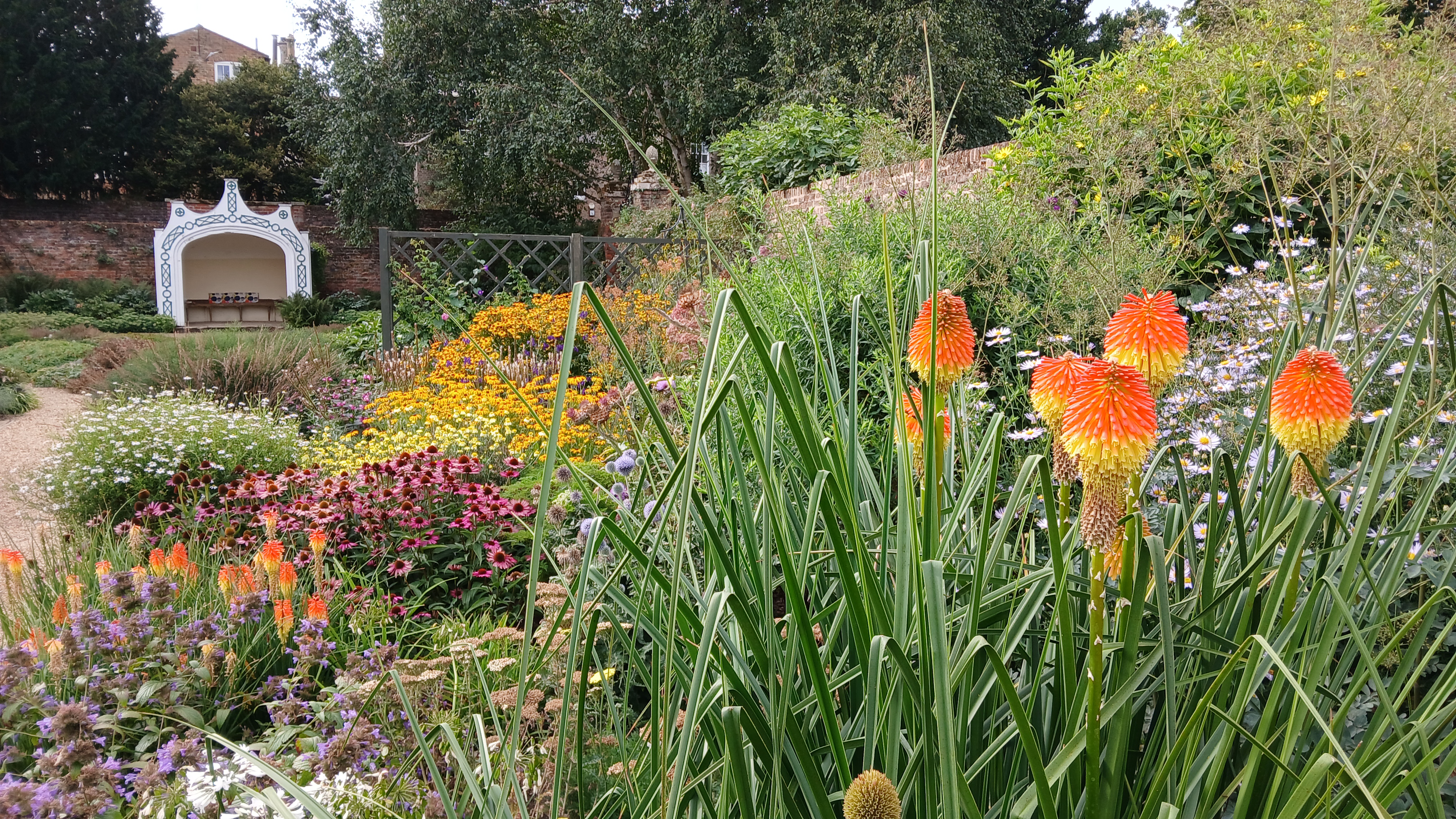 A bursting mingled border in the walled garden at Peckover
